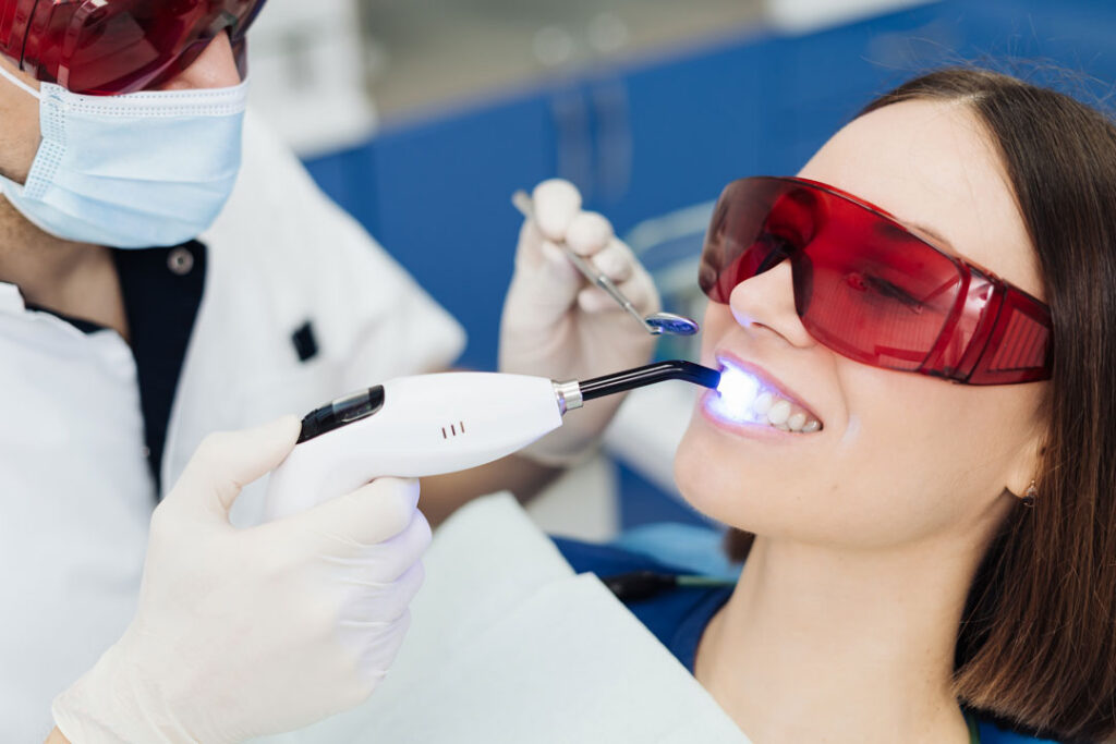 teeth whitening session underway by a dentist