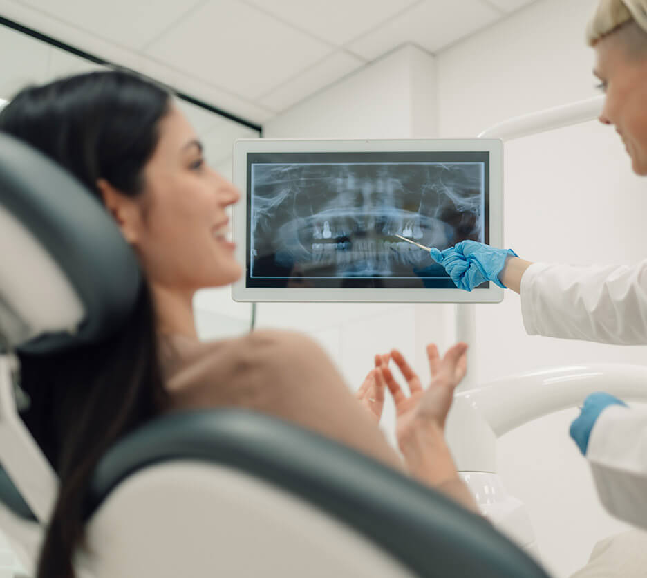a general dentist explaining mouth x-ray to her patient