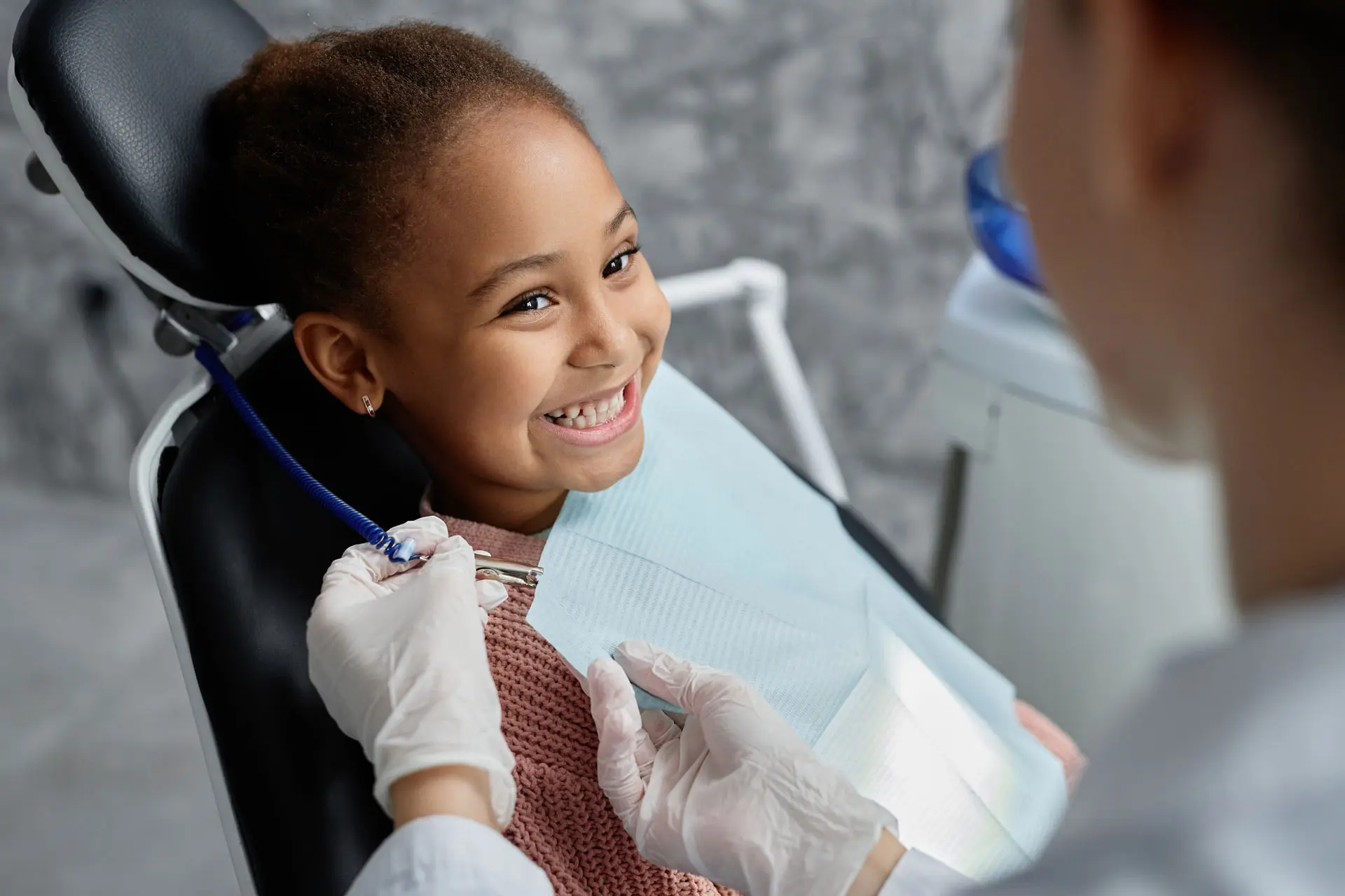 children dentistry - a young child getting her new patient dental exam