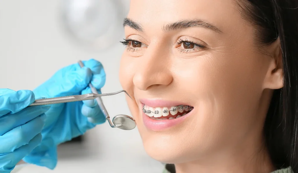 Dentist examining a patient wearing braces
